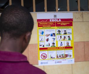 epa10212386 A man looks at an Ebola virus disease awareness campaign poster following an outbreak of Ebola in Uganda, in Kampala, Uganda, 28 September 2022. According to Uganda's Health Ministry, Ebola infections have risen across some districts in Uganda with the number of confirmed and suspected deaths at 36. The president addressed the nation on measures the government is putting in place to mitigate the spread.  EPA/Stringer