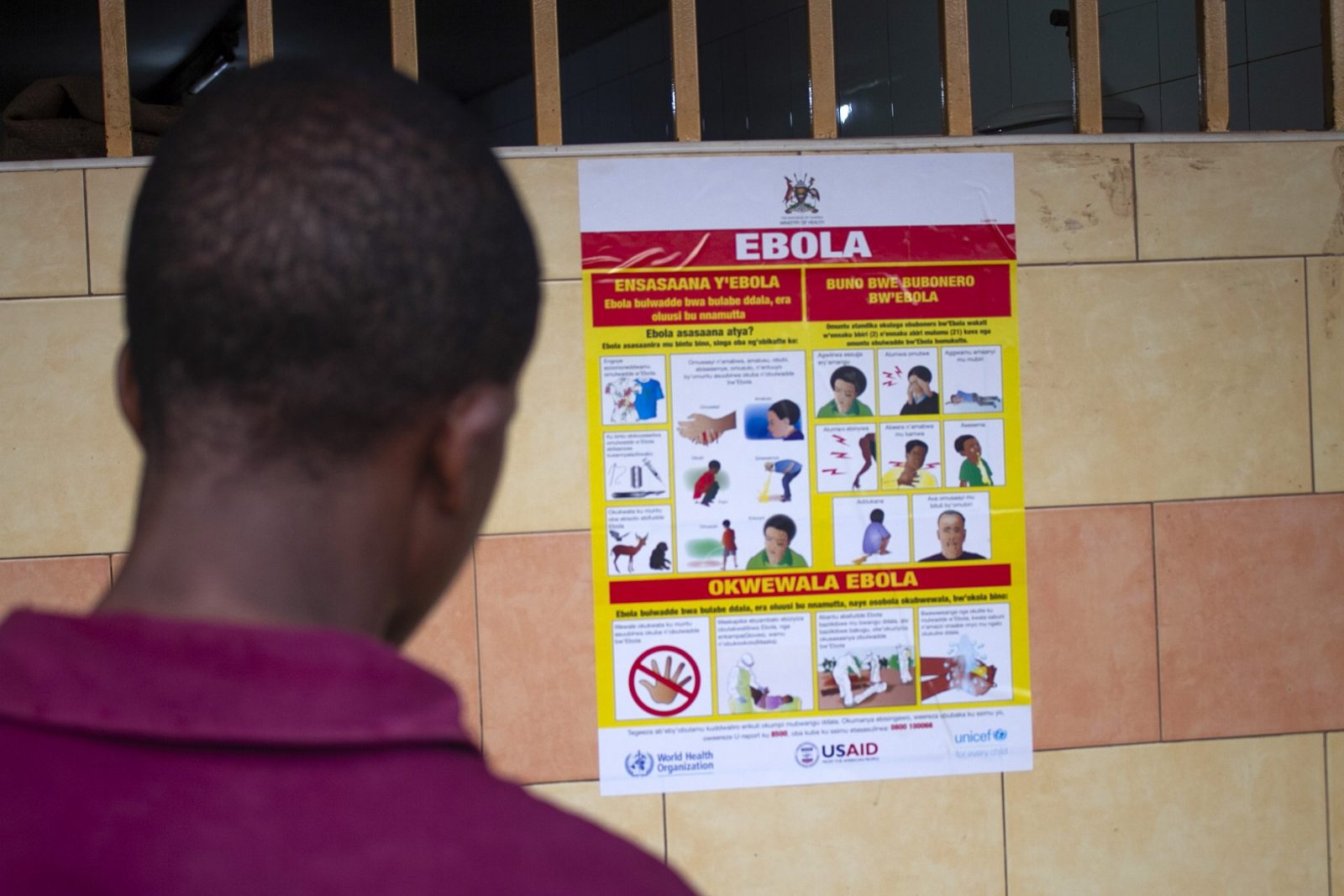 epa10212386 A man looks at an Ebola virus disease awareness campaign poster following an outbreak of Ebola in Uganda, in Kampala, Uganda, 28 September 2022. According to Uganda's Health Ministry, Ebola infections have risen across some districts in Uganda with the number of confirmed and suspected deaths at 36. The president addressed the nation on measures the government is putting in place to mitigate the spread.  EPA/Stringer