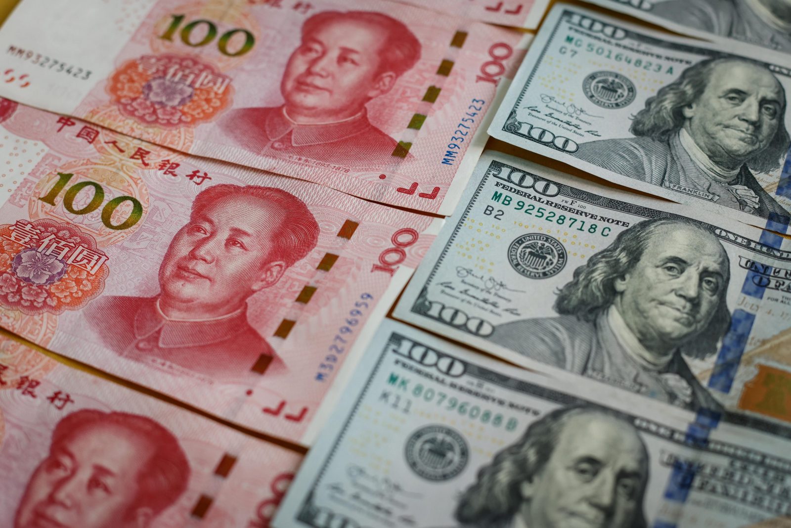 epa10212734 An illustration shows the 100 Chinese yuan or Renminbi (RMB) and 100 US dollar bills in Beijing, China, 29 September 2022. China's yuan hit a record low against US dollar on 28 September, the weakest since the global financial crisis in 2008, despite the central bank taking steps to rein in the currency's weakness.  EPA/MARK R. CRISTINO