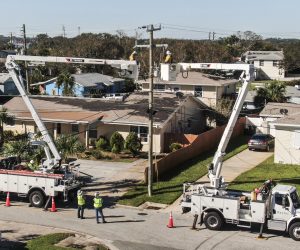 epa10219663 An aerial photo made with a drone shows linemen working to restore electricity in the wake of Hurricane Ian in Daytona Beach, Florida, 02 October 2022. The category 4 storm made land fall 28 September causing widespread damage and power outages.  EPA/TANNEN MAURY