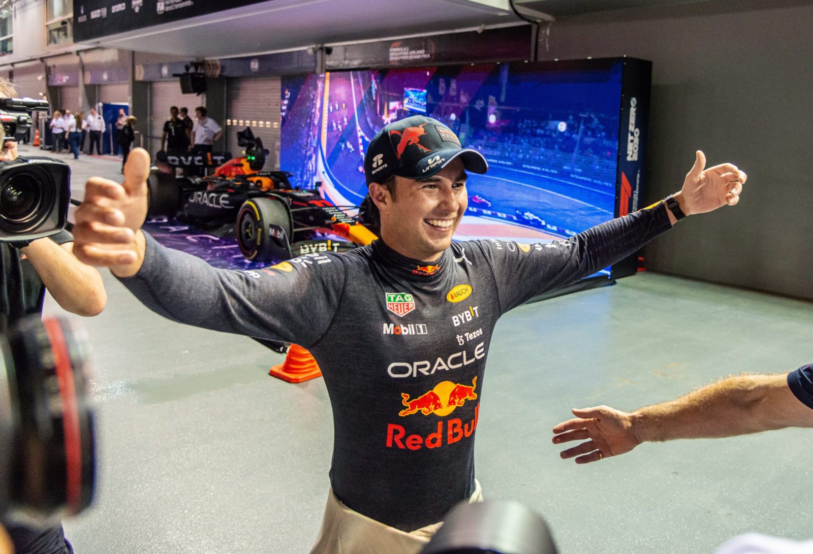 epa10219727 Mexican Formula One driver Sergio Perez of Red Bull Racing reacts after winning the Singapore Formula One Grand Prix race at the Marina Bay Street Circuit, Singapore, 02 October 2022.  EPA/TOM WHITE