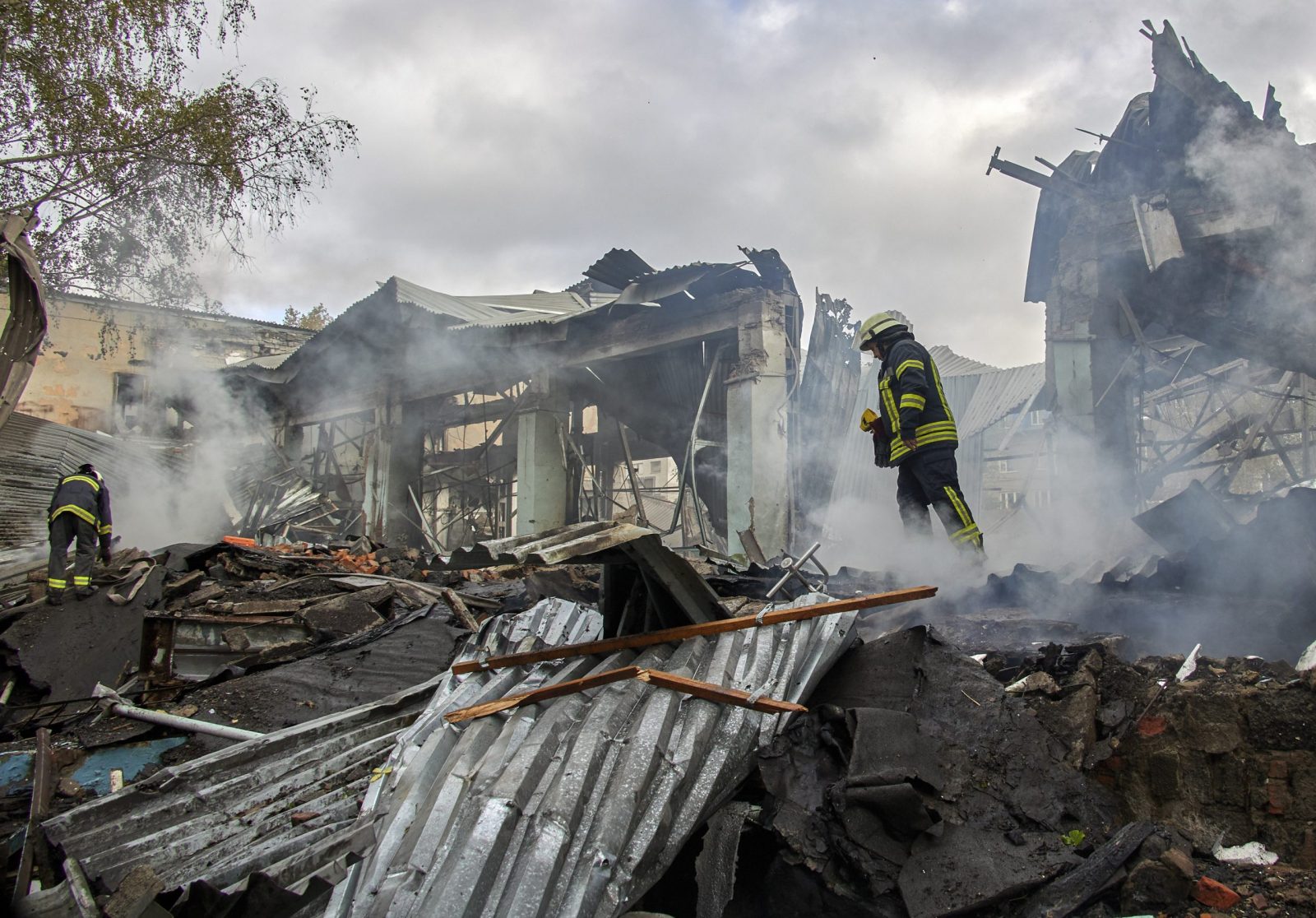 epa10222971 Ukrainian rescuers work to extinguish a fire in the rubble of a small factory damaged during shelling in Kharkiv, Ukraine, 04 October 2022 amid Russia's military invasion. According to Kharkiv Regional Prosecutor's office, the Russian military shelled Kharkiv from the territory of the Belgorod region of Russia presumably. The Ukrainian army pushed Russian troops from occupied territory in the northeast of the country in a counterattack. Kharkiv and surrounding areas have been the target of heavy shelling since February 2022, when Russian troops entered Ukraine starting a conflict that has provoked destruction and a humanitarian crisis.  EPA/SERGEY KOZLOV