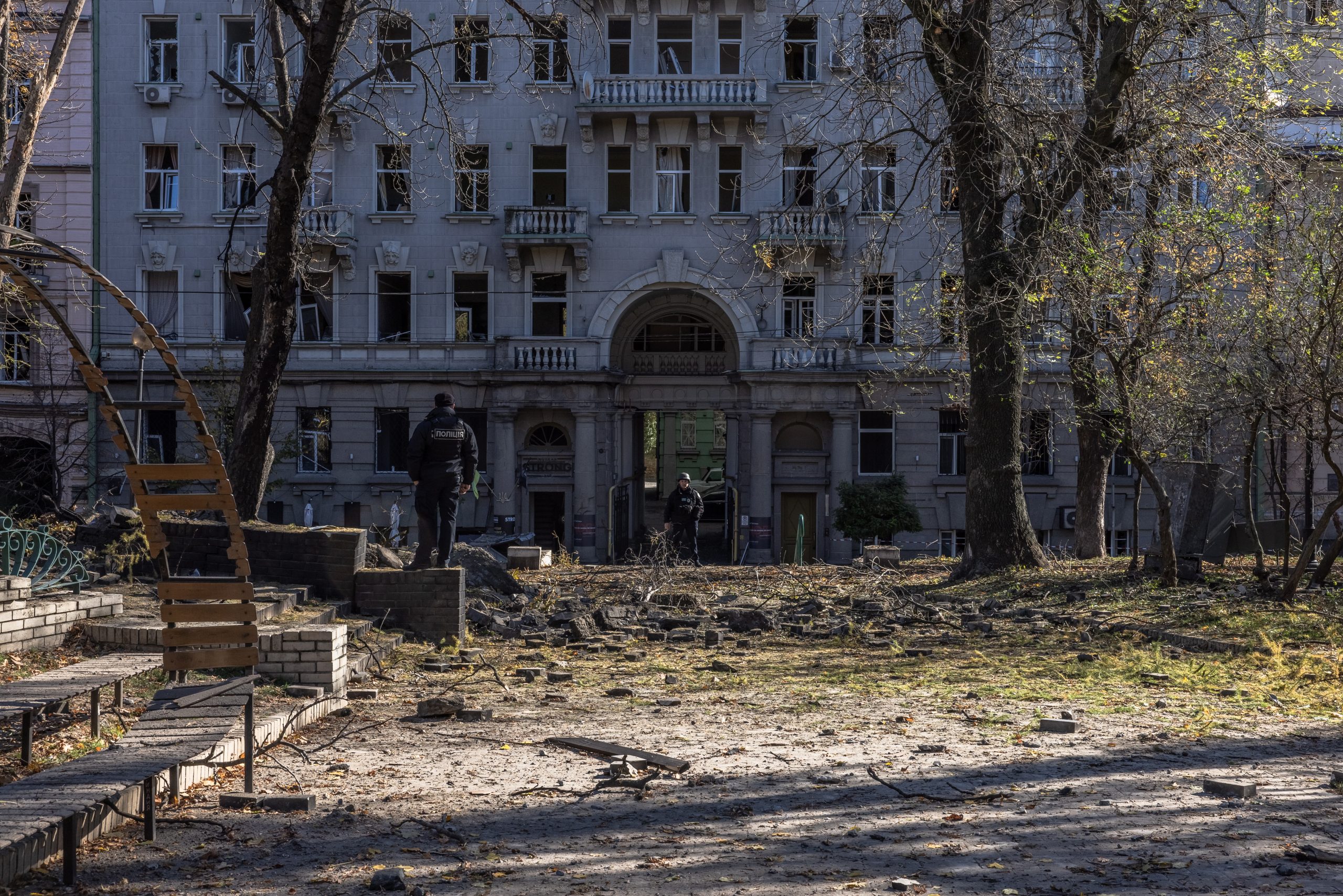 epa10234505 Police officers stand guard next to a damaged children's playground and buildings following missile strikes in downtown Kyiv (Kiev), Ukraine, 10 October 2022. Explosions have been reported in several districts of the Ukrainian capital Kyiv on 10 October. At least 11 people died and dozens injured as a result of rocket attacks targeting cities across Ukraine, the State Emergency Service (SES) of Ukraine said. Russian troops entered Ukraine on 24 February 2022 starting a conflict that has provoked destruction and a humanitarian crisis.  EPA/ROMAN PILIPEY
