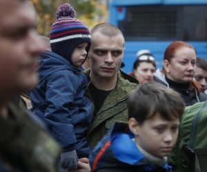 epa10238559 Russian conscripted man holds his child near a recruiting office during Russia's partial military mobilization in Moscow, Russia, 12 October 2022. Russian President Putin announced in a televised address to the nation on 21 September, that he signed a decree on partial mobilization in the Russian Federation due to the conflict in Ukraine. Russian Defense Minister Shoigu said that 300,000 people would be called up for service as part of the move.  EPA/YURI KOCHETKOV