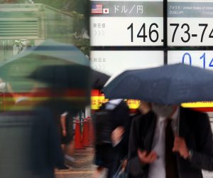 epa10240037 Pedestrians walk past a screen displaying the Japanese yen exchange rate against the US dollar in Tokyo, Japan, 13 October 2022. The yen fell against the US dollar to reach the upper 146 range.  EPA/JIJI PRESS JAPAN OUT EDITORIAL USE ONLY/