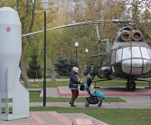 epa10240472 A woman pushes a baby stroller behind a monument dedicated to the first mass produced Soviet tactical nuclear bomb RDS-4 (L) at the Fedora Poletayeva square in Moscow, Russia, 13 October 2022. The Soviet tactical nuclear bomb RDS-4, knicknamed 'Tatyana', with a yield of 28 kt was first tested on 23 August 1953 at the Semipalatinsk Test Site.  EPA/MAXIM SHIPENKOV