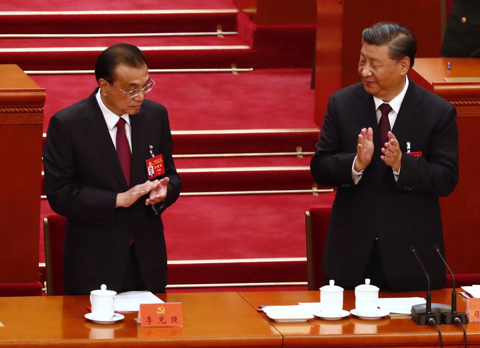 epa10258206 Chinese President Xi Jinping (R) and Premier Li Keqiang react during the closing ceremony of the 20th National Congress of the Communist Party of China (CPC) at the Great Hall of People in Beijing, China, 22 October 2022. The 20th National Congress of the Communist Party of China will close on 22 October with President Xi Jinping expected to secure a historic third five-year term in power.  EPA/WU HAO