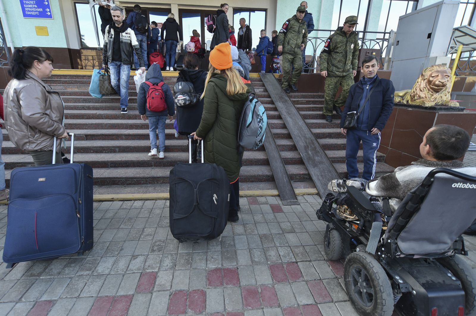 epa10263122 Local people evacuated from Kherson arrive to railway station in Dzhankoi, Crimea, 24 October 2022, where temporary accomodation centers have been set up. The authorities of the Kherson region announced the mass displacement of residents of several municipalities, including the city of Kherson, to the left bank of the Dnieper. According to the Acting Governor of the region Vladimir Saldo, this is necessary because of the increased frequency of attacks by the Armed Forces of Ukraine, as well as in connection with the threat of flooding of the territories due to the possible destruction of the dam of the Kakhovskaya hydroelectric power station. According to the deputy head of the regional administration Kirill Stremousov, about 30,000 people were transported to the other side of the Dnieper.  EPA/STRINGER
