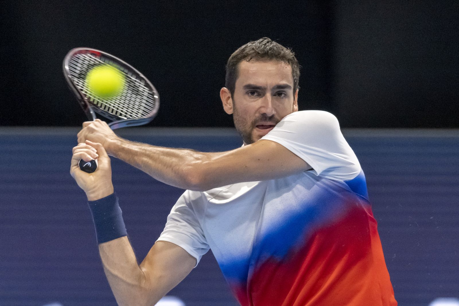 epa10263842 Croatia's Marin Cilic returns a ball to France's Arthur Rinderknech during their first round match at the Swiss Indoors tennis tournament, in Basel, Switzerland, 24 October 2022.  EPA/GEORGIOS KEFALAS