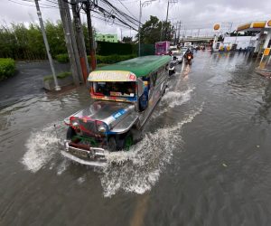 epa10272566 A Jeepney, a popular and uniquely Filipino mode of mass transport, drives through a flooded road in Las Pinas city, Metro Manila, Philippines, 29 October 2022. Data from the National Disaster Risk Reduction and Management Council (NDRRMC) showed that 45 people died from the effects of Typhoon Nalgae as of 29 October. Tracking by the country’s weather bureau places the typhoon in the southern Luzon region moving in a west southwestward direction.  EPA/FRANCIS R. MALASIG