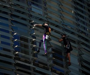 French climber Alain Robert, also known as "The French Spiderman", and his son Julien Robert climb a skyscraper Torre Agbar to spread awareness towards Global Climate Change in Barcelona, Spain October 1, 2022. REUTERS/Albert Gea Photo: ALBERT GEA/REUTERS