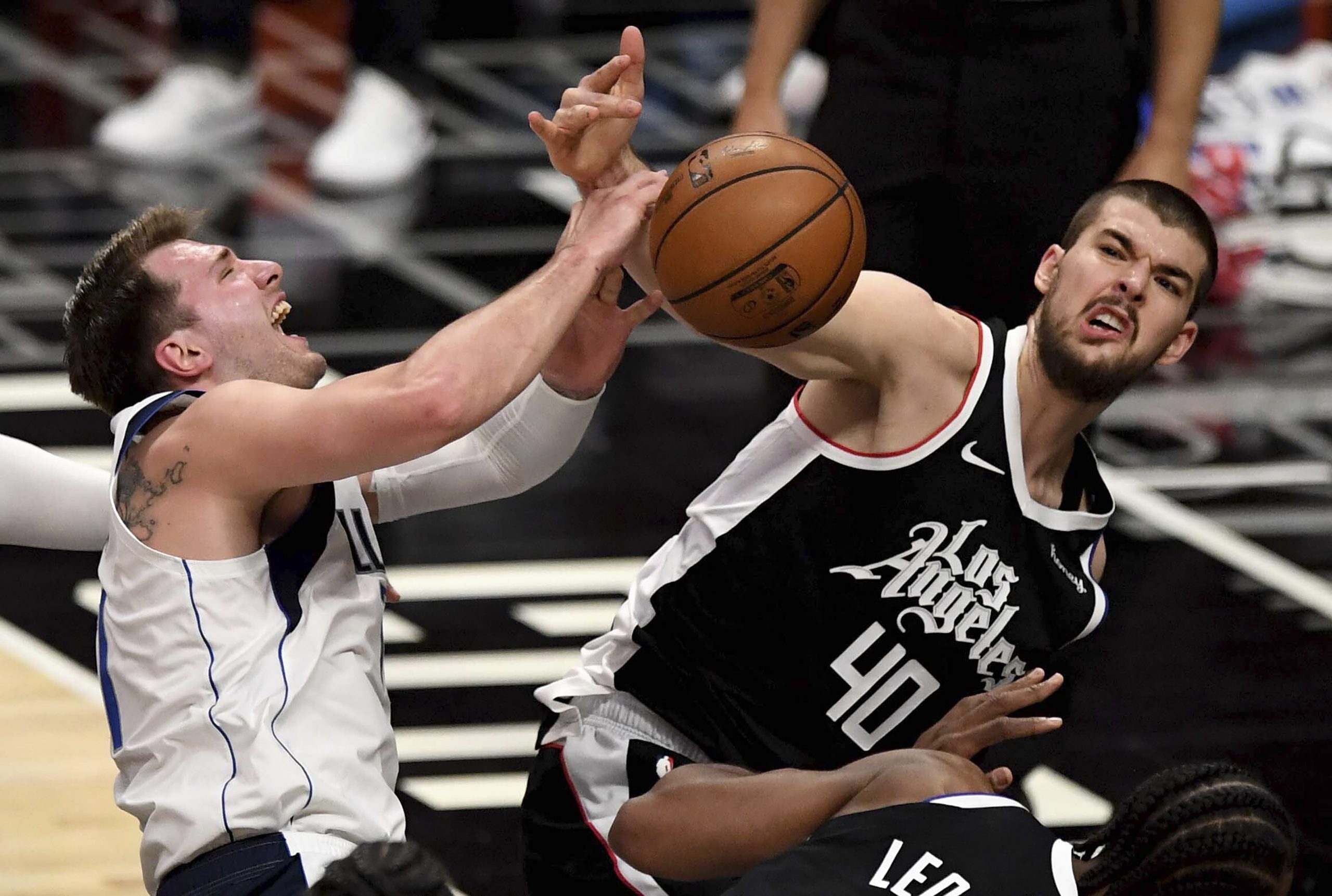 Luka Doncic #77 of the Dallas Mavericks is fouled by Ivica Zubac #40 of the LA Clippers in the first half of game five of the Western Conference First Round NBA Playoff basketball game at the Staples Center in Los Angeles on Wednesday, June 2, 2021. (Keith Birmingham/The Orange County Register via AP)/The Orange County Register via AP)