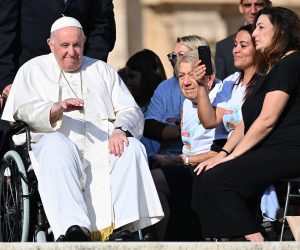 epa10237864 Pope Francis, sitting on a wheelchair, blesses the faithful during the weekly general audience in Saint Peter's Square, Vatican City, 12 October 2022.  EPA/ETTORE FERRARI