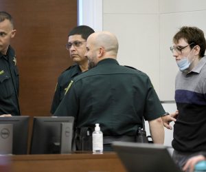 epa10240919 Marjory Stoneman Douglas High School shooter Nikolas Cruz leans against a wall waiting to be escorted from the courtroom as the jury resumes deliberations in the penalty phase of his trial at the Broward County Courthouse in Fort Lauderdale, Florida, USA, 13 October 2022. Cruz, who plead guilty to 17 counts of premeditated murder in the 2018 shootings, is the most lethal mass shooter to stand trial in the U.S. He was previously sentenced to 17 consecutive life sentences without the possibility of parole for 17 additional counts of attempted murder for the students he injured that day.  EPA/AMY BETH BENNETT / POOL