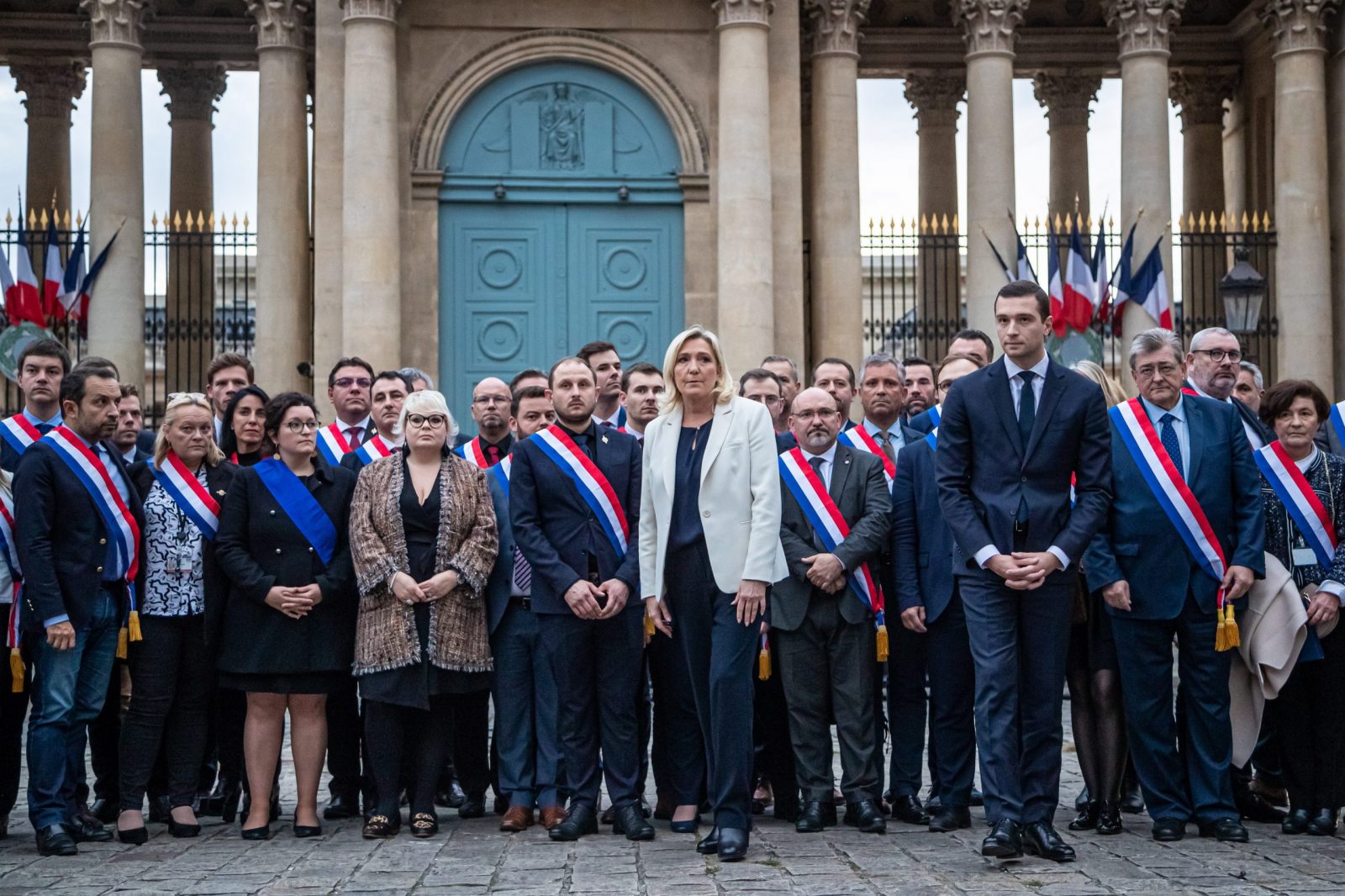 epa10255208 French far-right party Rassemblement National (RN) leader and Member of Parliament Marine Le Pen (C) and European Parliament member Jordan Bardella (C-R) flanked by RN’s Mps gather in front of the National Assembly to observe a minute of silence for Lola,  a young girl murdered in a northern district of French capital, in Paris, France, 20 October 2022. Lola, aged 12, was found dead in a trunk near the building where her parents are caretakers. Her death has sparked a political controversy over immigration as an Algerian woman has been arrested and is suspected of being the perpetrator.  EPA/CHRISTOPHE PETIT TESSON