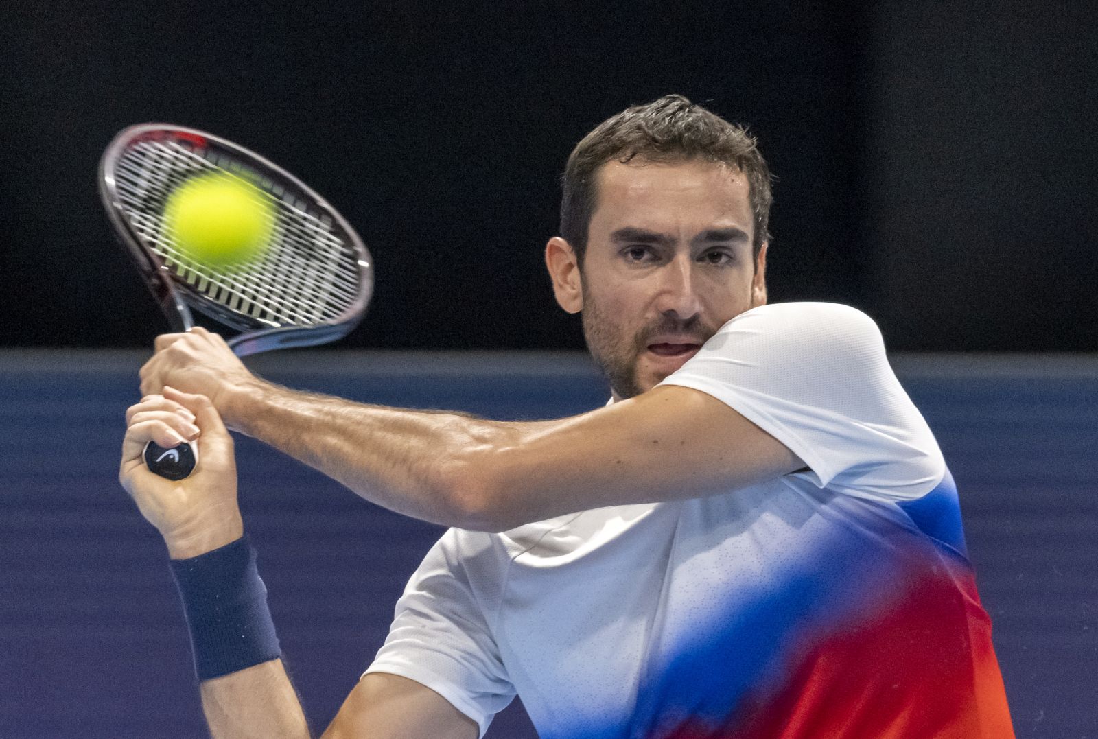 epa10263842 Croatia's Marin Cilic returns a ball to France's Arthur Rinderknech during their first round match at the Swiss Indoors tennis tournament, in Basel, Switzerland, 24 October 2022.  EPA/GEORGIOS KEFALAS