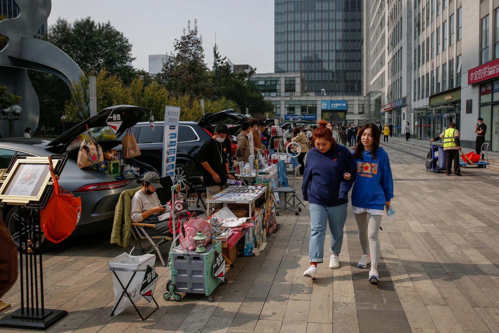 epa10264327 People walk along a car boot fair in Beijing, China, 25 October 2022. China's Gross Domestic Product (GDP) rose to 3.9 percent year-on-year in the third quarter of 2022 which beat the forecast of 3.2-3.3 percent. According to the International Monetary Fund, the forecast for China's growth in 2022 will expand only by 3.2 percent, far from the target of 5.5 percent, the lowest since the 1980's as the economy continues to be disrupted by COVID-19 measures.  EPA/MARK R. CRISTINO
