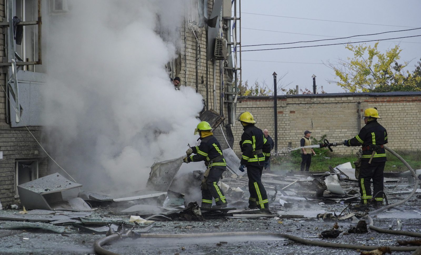 epa10264089 Russian firefighters extinguish a fire at the site of a car explosion near the 'ZaTV' broadcaster building in Melitopol, Zaporizhzhia region, southeastern Ukraine, 25 October 2022. At least five people were injured after a car exploded near the building of the 'ZaTV' television company in the city of Melitopol, said journalist Alexander Malkevich, a member of the Russian Public Chamber who oversees the work of the television company.  EPA/STRINGER