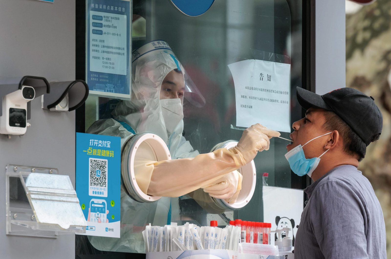 epa10270977 A man takes a Coronavirus PCR test on the street testing booth, in Shanghai, China, 28 October 2022. According to the Shanghai Health Commission report on 28 October, Shanghai city reported 11 local asymptomatic infections of COVID-19. 27 October, was the third day that China reported more than 1000 new cases nationwide. Therefore, cities from Xining in the northwest, through Wuhan in central China, to Guangzhou in the south, are locking down districts and sealing up buildings doubling down on COVID-19 curbs.  EPA/ALEX PLAVEVSKI