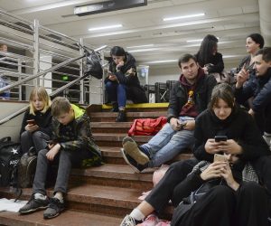 epa10276511 People check their phones as they shelter inside a metro station after a shelling in Kyiv (Kiev), Ukraine, 31 October 2022, amid the ongoing Russian invasion. Explosions have been reported in several districts around Ukraine on 31 October. Kyiv Mayor Vitali Klitschko said on social media that power engineers were working to restore electricity supply after damage to an energy facility that powers around 350,000 apartments in Kyiv. Some parts of the city were left with no water as a result of strikes on critical infrastructure facilities, the mayor added.  EPA/ANDRII NESTERENKO