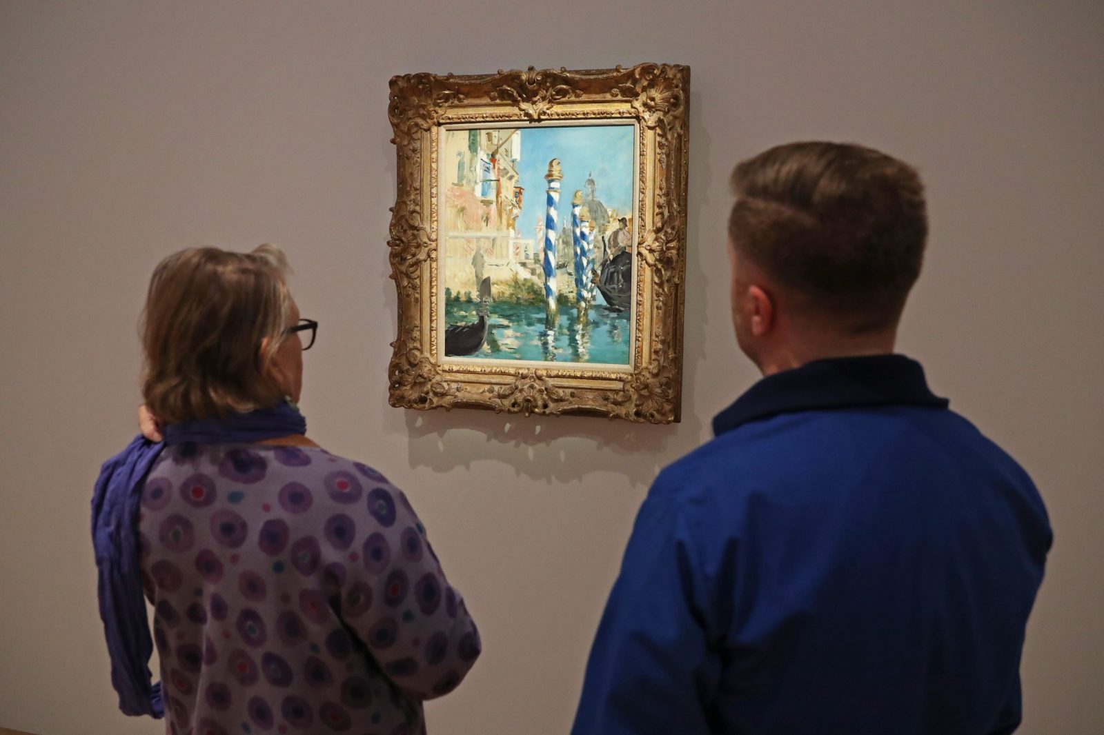 epa10277353 People view 'Le Grand Canal a Venise' by French painter Edouard Manet, estimated at 45 to 65 million USD, during a preview of the sale 'Visionary: The Collection of Paul G. Allen' at Christie's Auction House in New York, New York, USA, 31 October 2022.  EPA/SARAH YENESEL