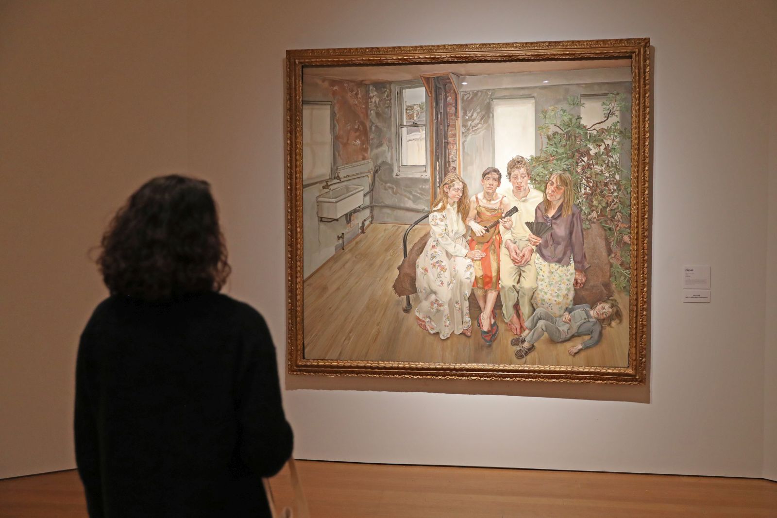 epa10277350 A person views 'Large Interior W11 (after Watteau)' by British artist Lucian Freud, estimated in excess of 75 million USD, during a preview of the sale 'Visionary: The Collection of Paul G. Allen' at Christie's Auction House in New York, New York, USA, 31 October 2022.  EPA/SARAH YENESEL