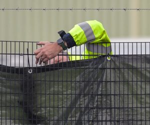 epa10279034 A security guard secures a screen at the outer perimeter at Manston immigration center, a short-term holding facility in Manston, Kent, Britain, 01 November 2022. British Home Secretary Suella Braverman whilst speaking in the House of Commons on 31 October 2022 denied ignoring legal advice to procure more accommodation amid warnings that Manston is dangerously overcrowded. The Chief Inspector of Prisons Charlie Taylor who has recently inspected the center stated that the Home Office needs to 'get a grip' of the situation.  EPA/STUART BROCK