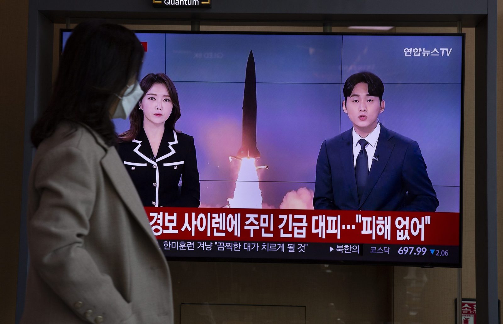 epa10280871 A woman watches the news at a station in Seoul, South Korea, 02 November 2022. According to South Korea's Joint Chiefs of Staff (JCS), North Korea launched at least three short-range ballistic missiles (SRBMs) into the East Sea, one of which flew across its de facto maritime border with South Korea.  EPA/JEON HEON-KYUN