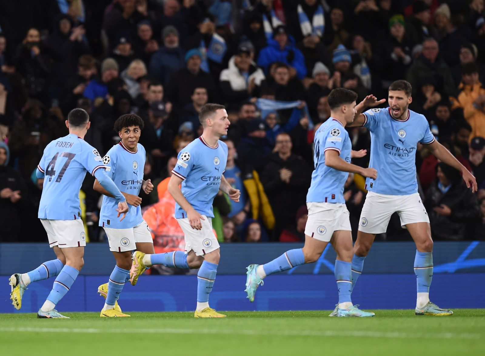 epa10282479 Manchester City's Rico Lewis celebrates with teammates after scoring the 1-1 during the UEFA Champions League group G soccer match between Manchester City and Sevilla FC in Manchester, Britain, 02 November 2022.  EPA/PETER POWELL