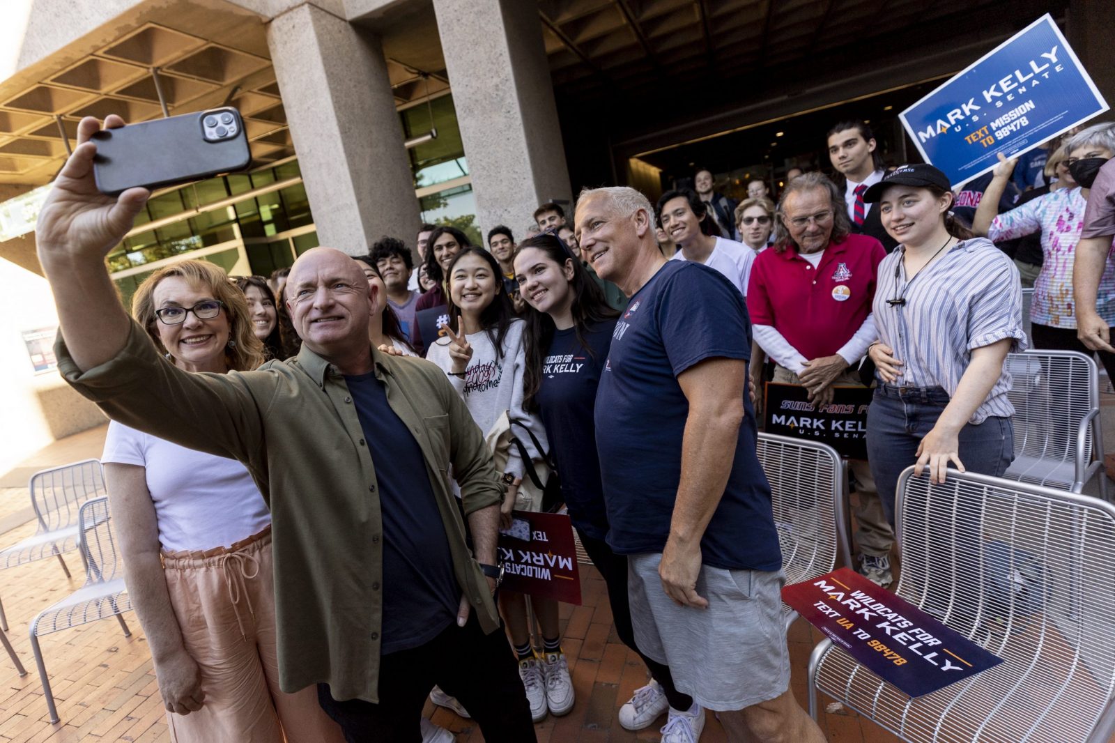 epa10291662 US Democratic Senator for Arizona and Senate candidate Mark Kelly (L) poses with supporters at the University of Arizona, in Tucson, Arizona, USA, 06 November 2022. The US midterm elections are held every four years at the midpoint of each presidential term and this year include elections for all 435 seats in the House of Representatives, 35 of the 100 seats in the Senate and 36 of the 50 state governors as well as numerous other local seats and ballot issues.  EPA/ETIENNE LAURENT