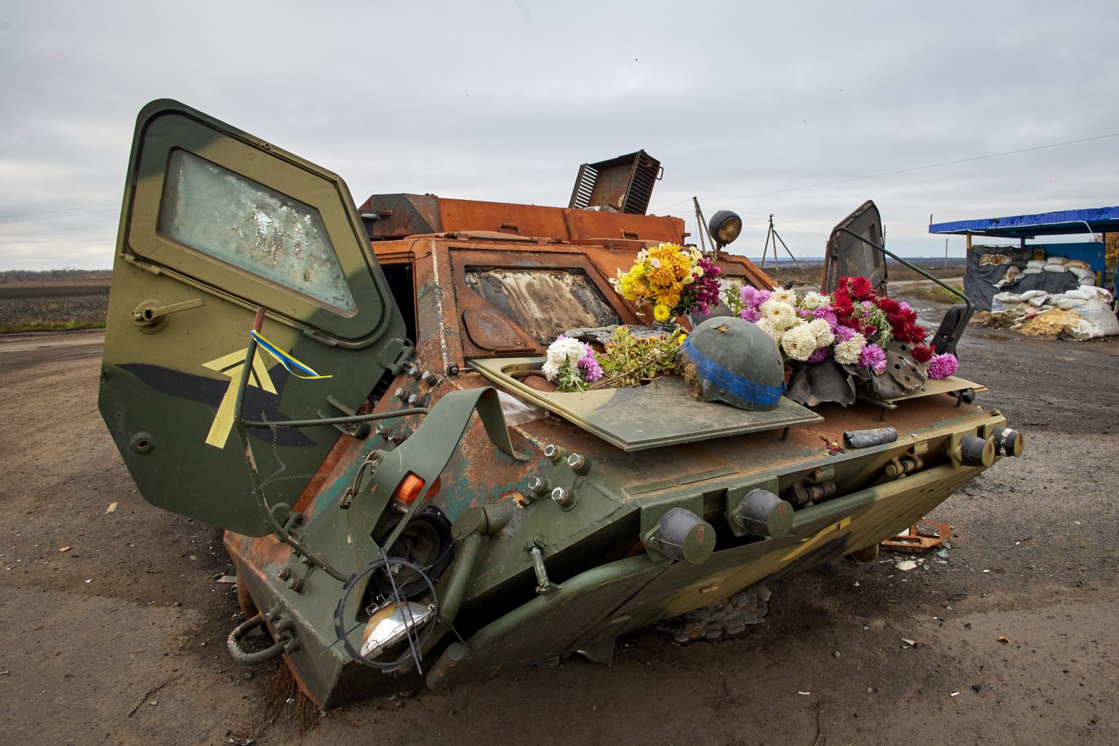 epa10292861 A damaged Ukrainian armoured personnel carrier (APC) with flowers on it put by local people in memory of the Ukrainian soldiers who died at this checkpoint, in the recently recaptured territory of the Kupiansk district, Kharkiv region, northeastern Ukraine, 07 November 2022, amid Russia's invasion. Kharkiv and surrounding areas have been the target of heavy shelling since February 2022, when Russian troops entered Ukraine starting a conflict that has provoked destruction and a humanitarian crisis. At the beginning of September 2022, the Ukrainian army pushed Russian forces from occupied territory in the northeast of the country in counterattacks.  EPA/SERGEY KOZLOV