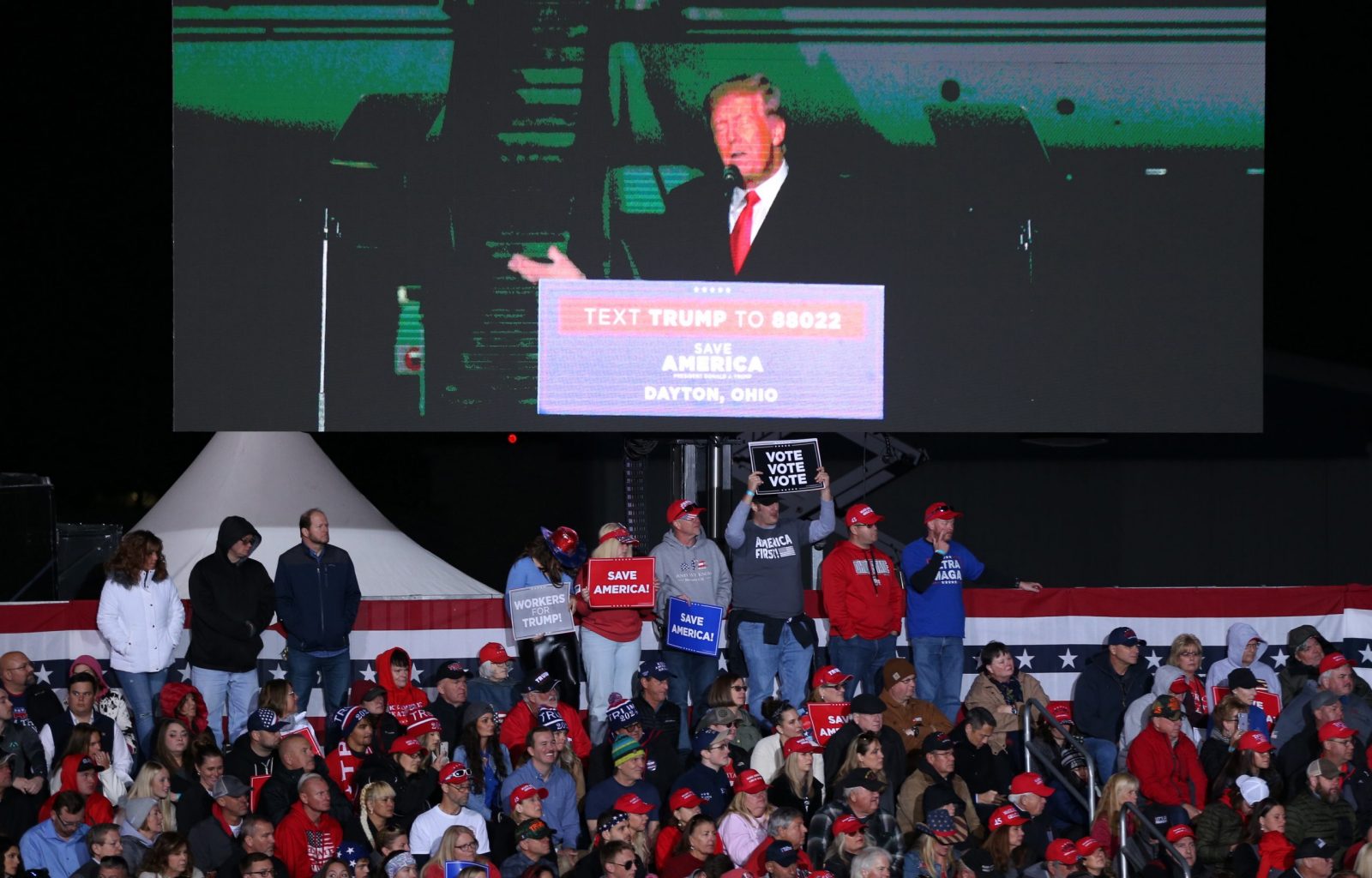 epa10293177 Former US President Donald J. Trump is shown on a digital display above supporters as he speaks at a rally at the Wright Bros. Aero Inc., at Dayton International Airport in Vandalia, Ohio, USA, 07 November 2022. Trump is holding rallies in support of Republican candidates before the midterm elections. The US midterm elections are held every four years at the midpoint of each Presidential term and include elections for all 435 seats in the House of Representatives, 33 or 34 of the 100 seats in the Senate and 36 of the 50 state governors as well as numerous other local seats and ballot issues.  EPA/MARK LYONS