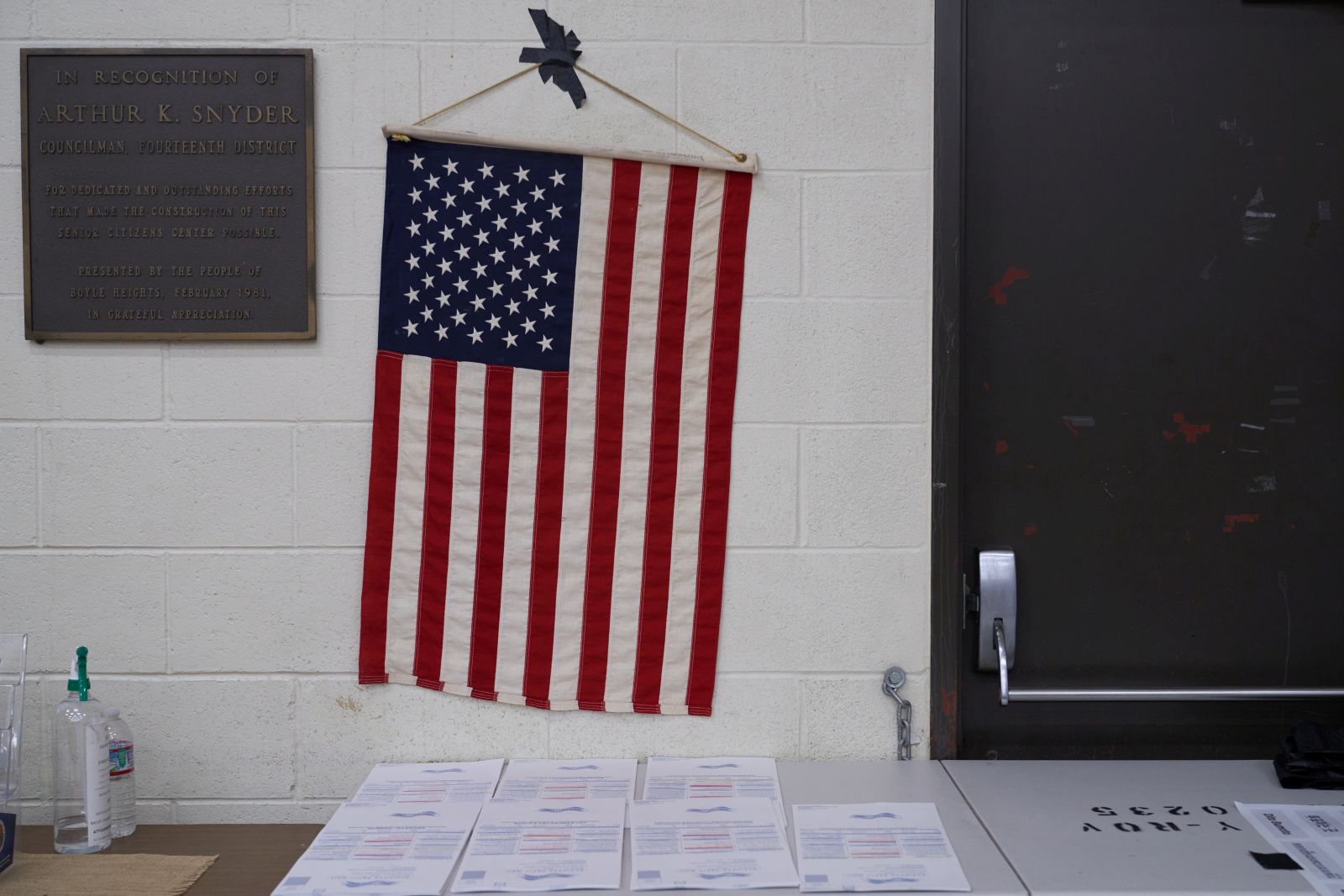 epa10294949 An American flag hangs above ballots at the Boyle Heights Senior Center in Los Angeles, California, USA, 08 November 2022. The US midterm elections are held every four years at the midpoint of each presidential term and this year include elections for all 435 seats in the House of Representatives, 35 of the 100 seats in the Senate and 36 of the 50 state governors as well as numerous other local seats and ballot issues.  EPA/ALLISON DINNER