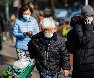 epa10297501 An elderly woman wearing a face mask walks on the street with her vegetable basket in Beijing, China, 10 November 2022. According to the National Health Commission report on 09 November, little over 30 new locally transmitted COVID-19 cases were detected in Beijing, the highest recorded in five months. More than 10 compounds in the Chaoyang district were put under lockdown.  EPA/WU HAO
