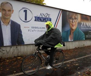 epa10298297 A man passes near huge pre-election posters of presidential candidates, Anze Logar and Natasa Pirc Musar, in downtown Ljubljana, Slovenia, 10 November 2022. The second round of the 2022 Slovenian presidential election takes place on 13 November between Anze Logar and Natasa Pirc Musar.  EPA/ANTONIO BAT