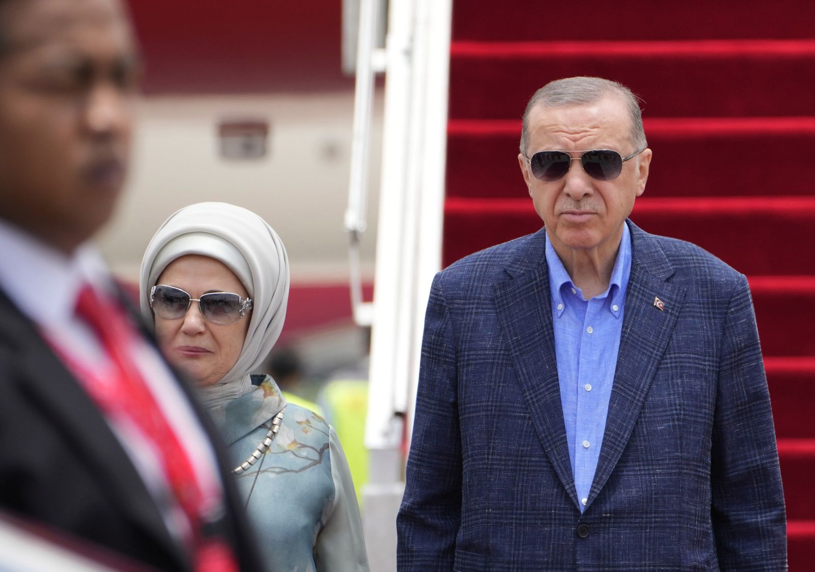 epa10304895 Turkish President Recep Tayyip Erdogan (C) and his wife Emine (2-L) disembark from their plane as they arrive at Ngurah Rai International Airport ahead of the G20 Summit in Bali, Indonesia,14 November 2022. The 17th Group of Twenty (G20) Heads of State and Government Summit will be held in Bali from 15 to 16 November 2022.  EPA/FIRDIA LISNAWATI / POOL