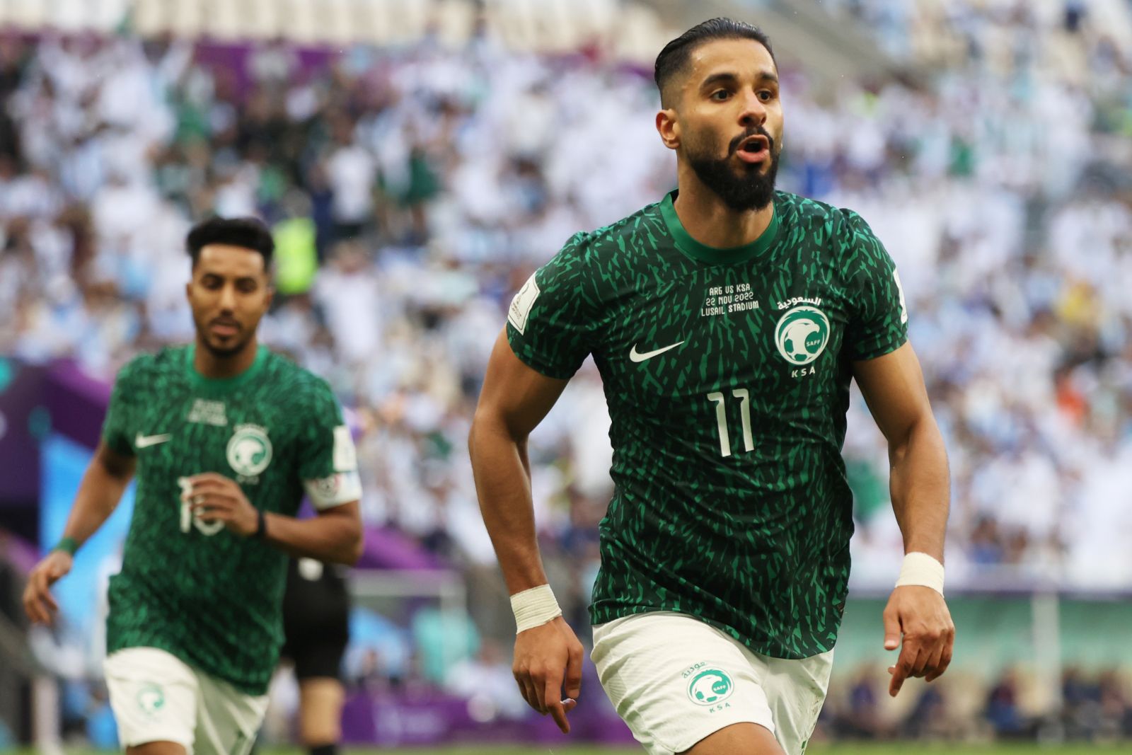 epa10319965 Saleh Alshehri (R) of Saudi Arabia celebrates after scoring the 1-1 equalizer in the FIFA World Cup 2022 group C soccer match between Argentina and Saudi Arabia at Lusail Stadium in Lusail, Qatar, 22 November 2022.  EPA/Mohamed Messara