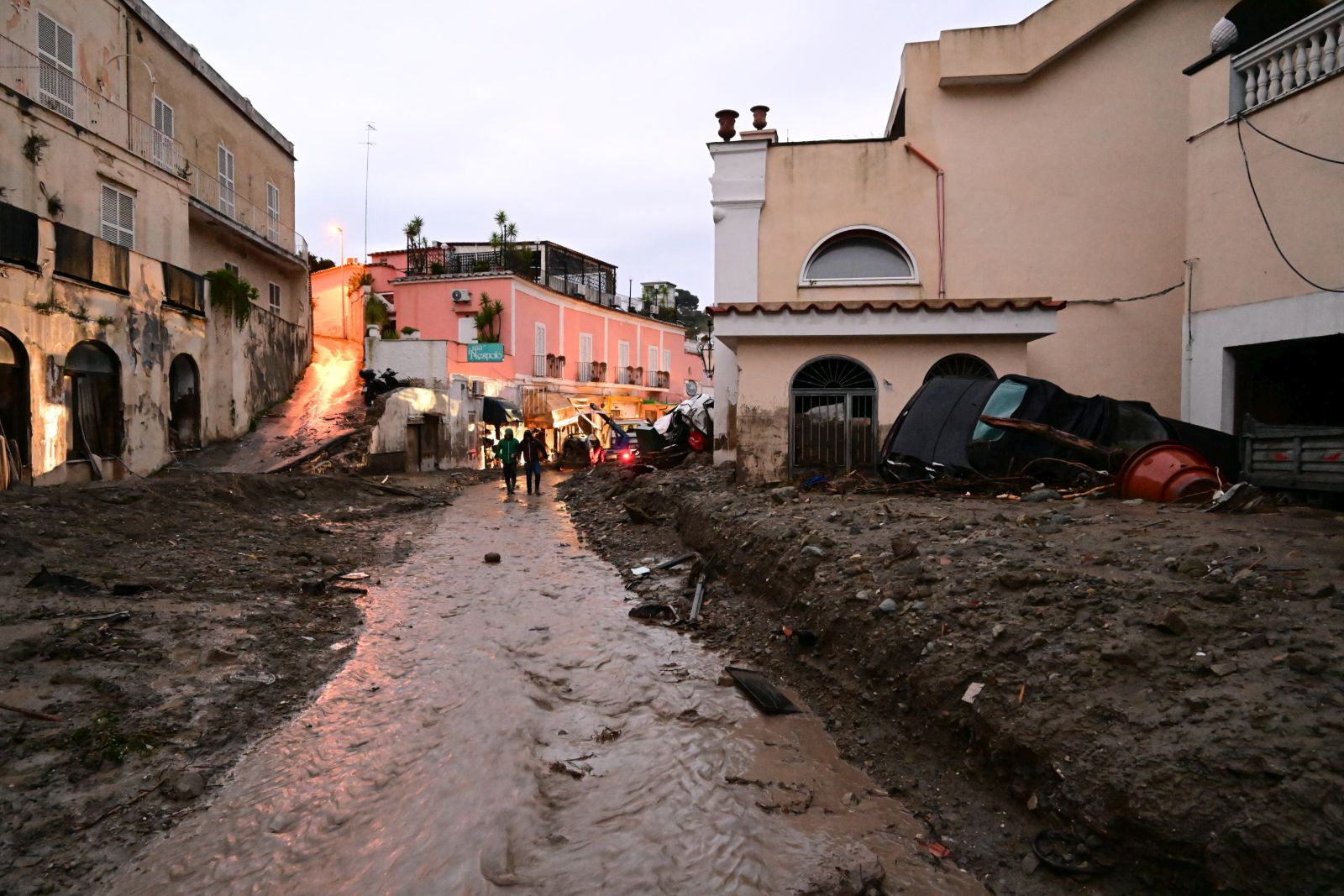 epa10330546 An area affected by a landslide in Ischia island, in the Gulf of Naples, Italy, 26 November 2022. A group of people are feared to be missing after heavy rain caused a landslide from the top of the Epomeo mountain, at a height of about 780 meters, and reached the seafront, overwhelming some parked cars and dragging them to the sea.  EPA/CIRO FUSCO ITALY OUT