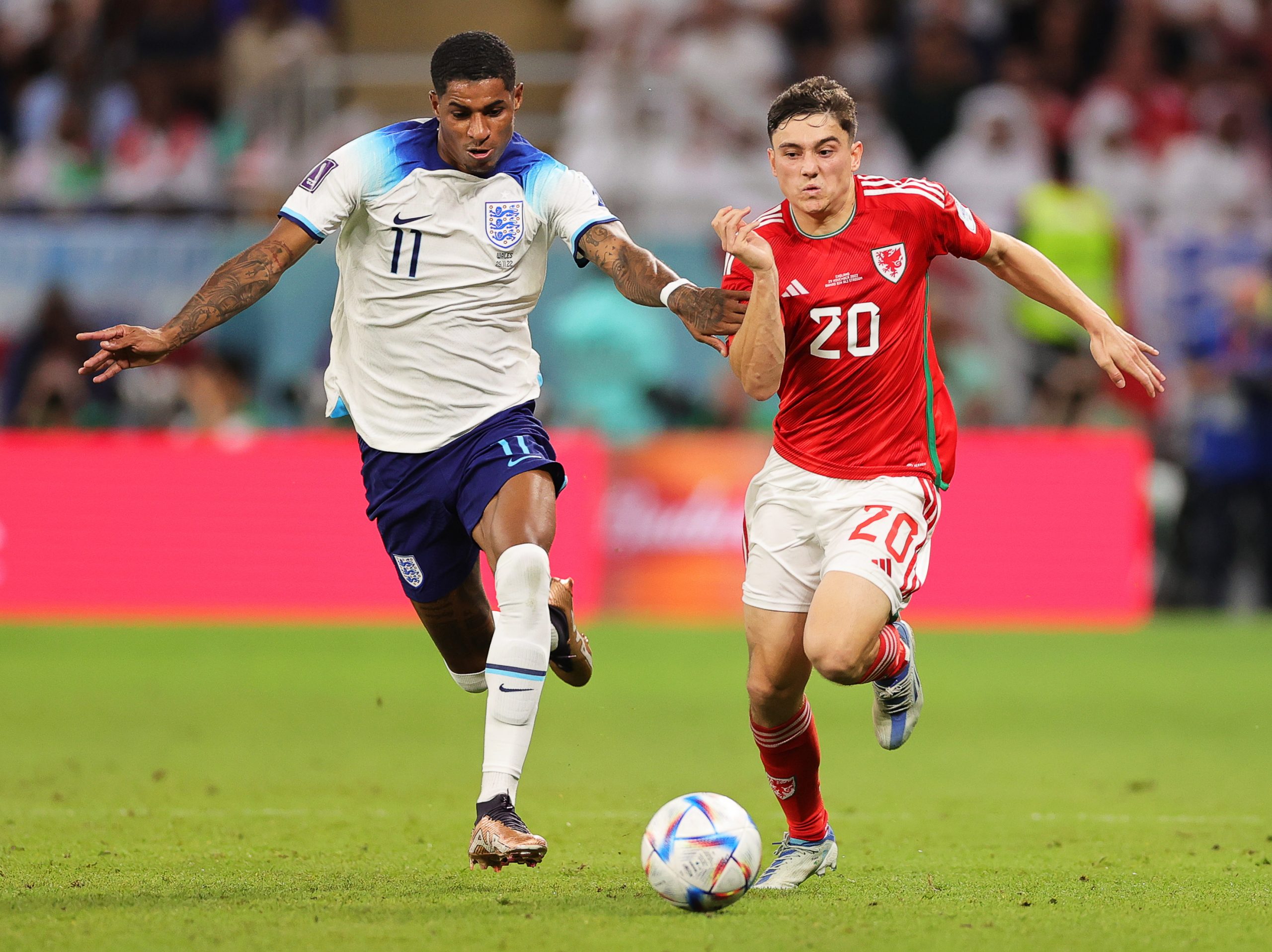 epa10337410 Marcus Rashford (L) of England in action against Daniel James (R) of Wales during the FIFA World Cup 2022 group B soccer match between Wales and England at Ahmad bin Ali Stadium in Doha, Qatar, 29 November 2022.  EPA/Friedemann Vogel