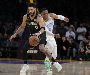 Boston Celtics' Jayson Tatum drives past Los Angeles Lakers' Russell Westbrook in overtime of an NBA basketball game Tuesday, Dec. 13, 2022, in Los Angeles. The Celtics won 122-118 in overtime. (AP Photo/Jae C. Hong)