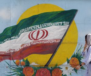epa10295546 A woman walks past a graffiti showing the Iranian national flag in Tehran, Iran, 09 November 2022. Iran has been rocked by anti-government protests, with supporters worldwide, following the death in September 2022 of Masha Amini, a 22-year-old girl who died while in police custody after being detained for breaking Iran's strict dress code for women. Iranian leaders condemned the protests and accused the United States and Israel of planning the uprising.  EPA/ABEDIN TAHERKENAREH