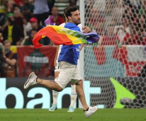 epa10335303 A pitch invader waves a rainbow flag during the FIFA World Cup 2022 group H soccer match between Portugal and Uruguay at Lusail Stadium in Lusail, Qatar, 28 November 2022.  EPA/Abir Sultan