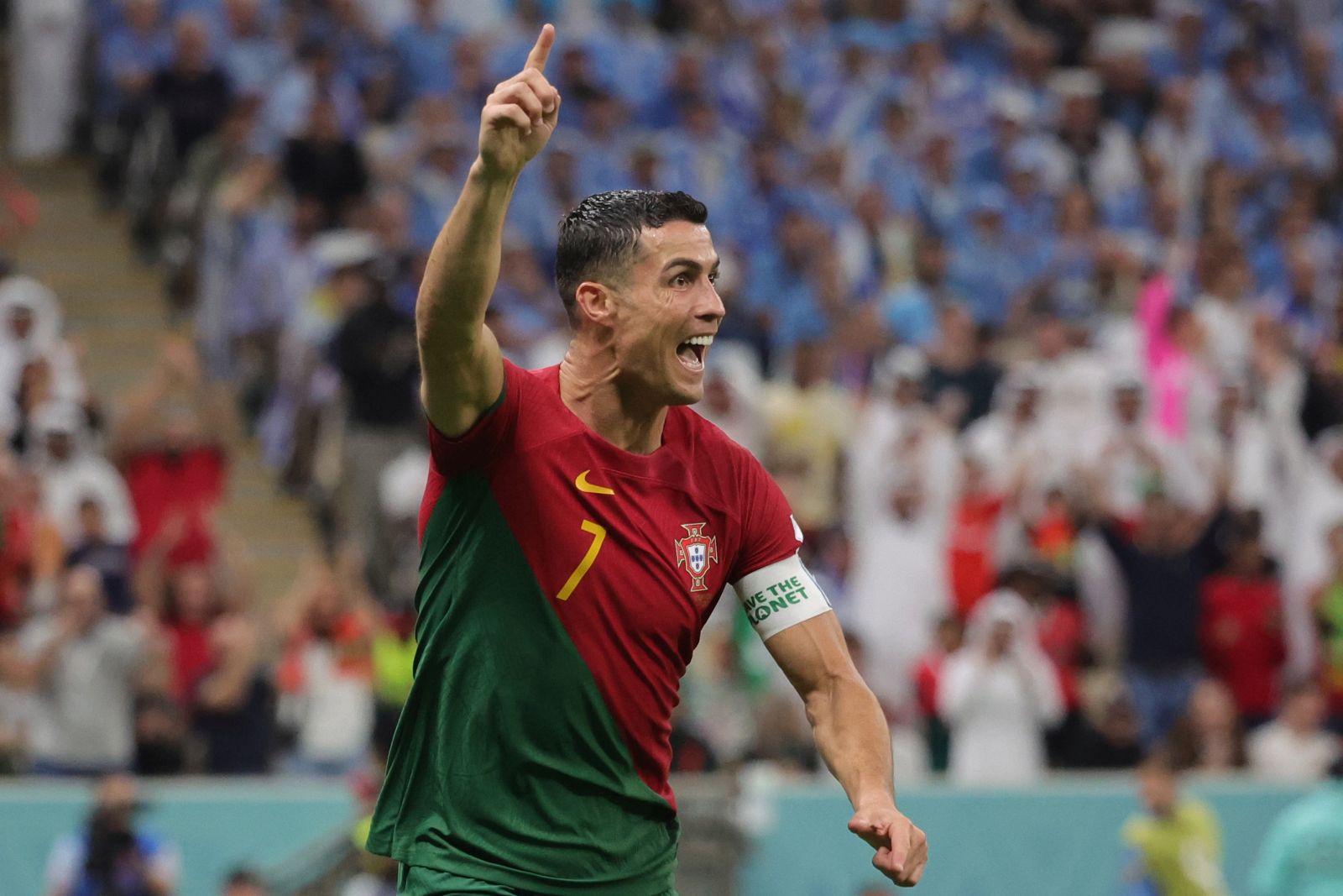 epa10335298 Cristiano Ronaldo of Portugal celebrates after scoring the 1-0 during the FIFA World Cup 2022 group H soccer match between Portugal and Uruguay at Lusail Stadium in Lusail, Qatar, 28 November 2022.  EPA/Abir Sultan