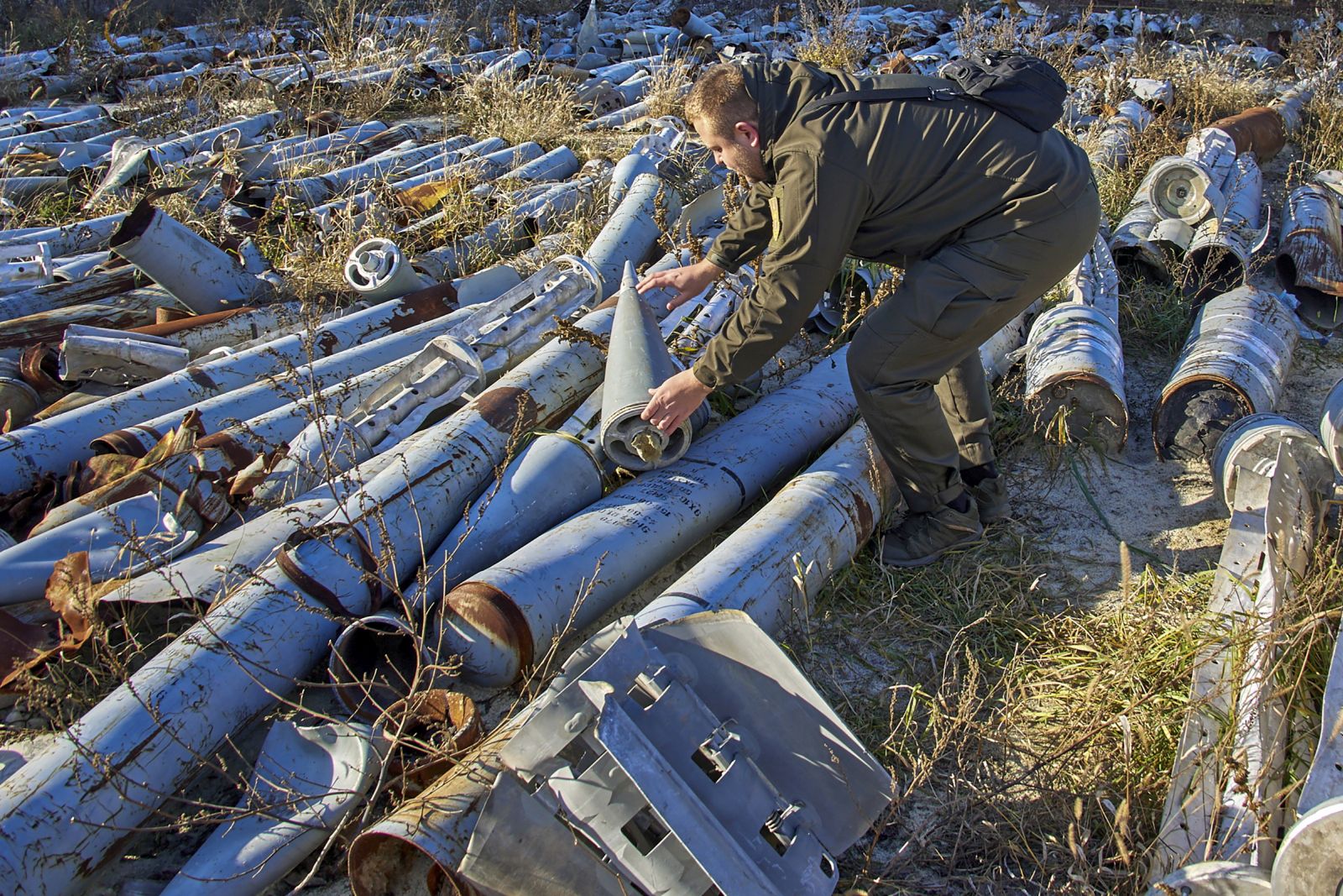epa10337013 A worker of the prosecutor's office looks at used missiles which was collected after shellings and is presented as evidence of Russian shellings against civilian targets, in Kharkiv, Ukraine, 29 November 2022. Kharkiv and surrounding areas have been the target of heavy shelling since February 2022, when Russian troops entered Ukraine starting a conflict that has provoked destruction and a humanitarian crisis. At the beginning of September, the Ukrainian army pushed Russian forces from occupied territory northeast of the country in counterattacks.  EPA/SERGEY KOZLOV