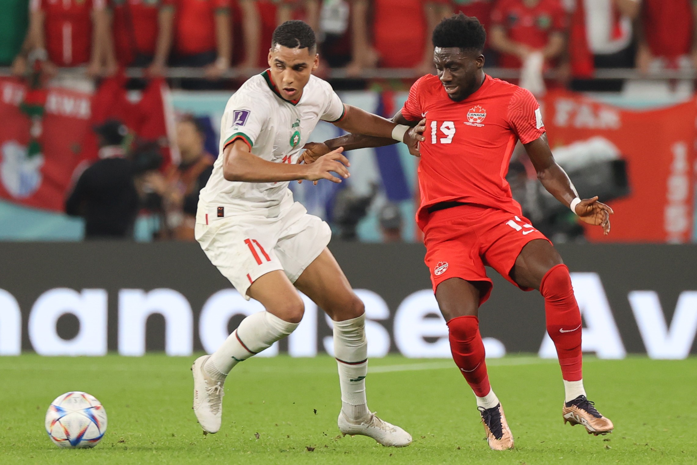 epa10341793 Alphonso Davies (R) of Canada in action against Abdelhamid Sabiri of Morocco during the FIFA World Cup 2022 group F soccer match between Canada and Morocco at Al Thumama Stadium in Doha, Qatar, 01 December 2022.  EPA/Mohamed Messara