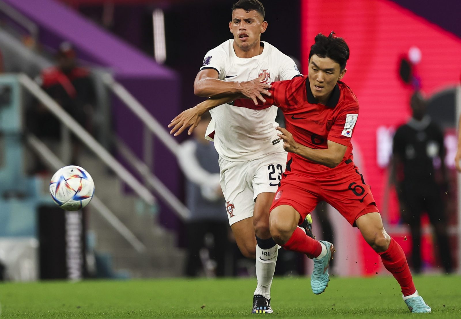 epa10344438 Inbeom Hwang (R) of South Korea in action against Matheus Nunes of Portugal during the FIFA World Cup 2022 group H soccer match between South Korea and Portugal at Education City Stadium in Doha, Qatar, 02 December 2022.  EPA/JOSE SENA GOULAO
