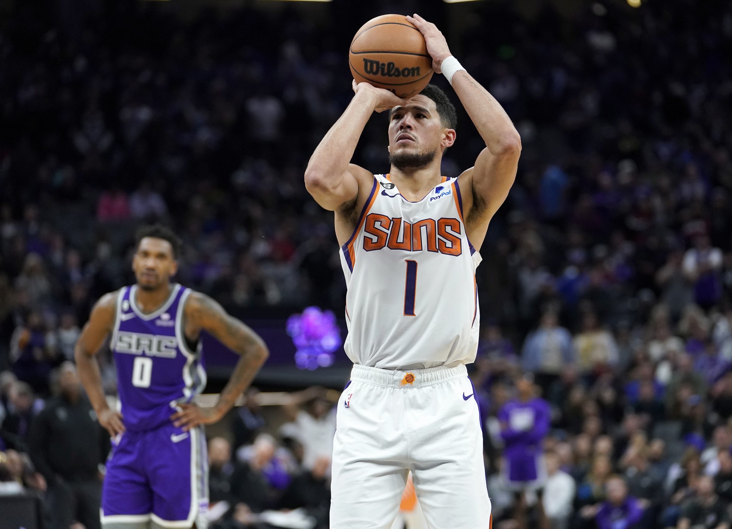 epa10335703 Phoenix Suns guard Devin Booker (R) shoots a free throw as Sacramento Kings guard Malik Monk (L) looks on during the second half of the NBA game at Golden 1 Center in Sacramento, California, USA, 28 November 2022.  EPA/JOHN G. MABANGLO  SHUTTERSTOCK OUT