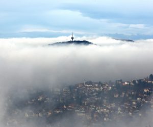 epa10345834 A television tower on a mountain peak pokes out of a low layer of fog covering the surroundings of the city of Sarajevo, Bosnia and Herzegovina, 03 December 2022. With an AQI (Air Quality Index) of 163, which is labelled as 'unhealty', the Bosinan capital is among the most polluted cities in the world, ranking on 6th place on 03 December 2022.  EPA/FEHIM DEMIR