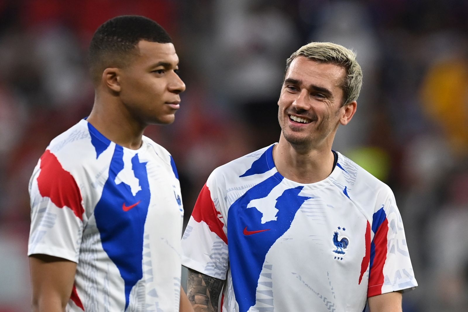 epa10347890 Kylian Mbappe (L) and Antoine Griezmann of France go through warm-up routines before the FIFA World Cup 2022 round of 16 soccer match between France and Poland at Al Thumama Stadium in Doha, Qatar, 04 December 2022.  EPA/Georgi Licovski