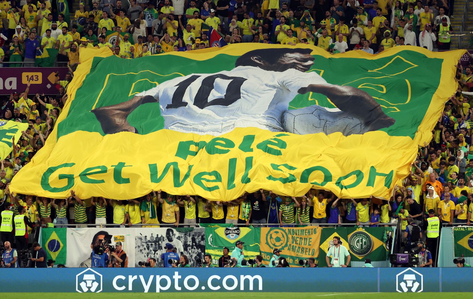 epa10350658 Fans of Brazil show a banner with which they wish Pele all the best during the FIFA World Cup 2022 round of 16 soccer match between Brazil and South Korea at Stadium 974 in Doha, Qatar, 05 December 2022.  EPA/Abedin Taherkenareh